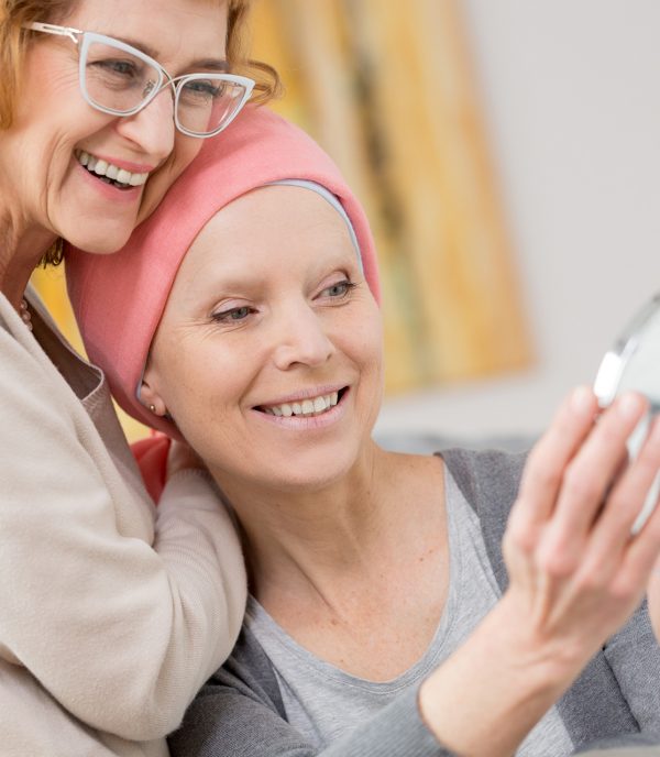 Sick woman with cancer trying on her new pink scarf